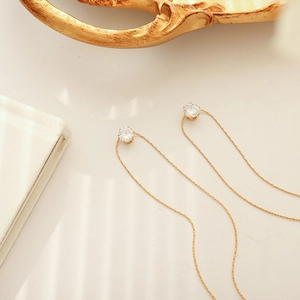 Elegant gold threader earrings featuring round zircon accents on a long chain design