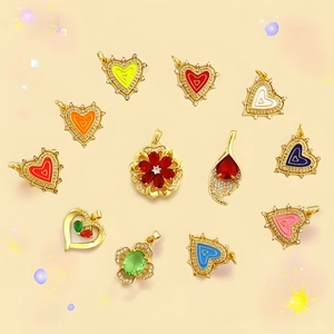 Macro shot of colorful heart and flower shaped zircon pendants with gold plating detail