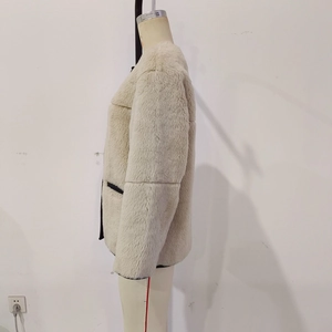 Detailed close-up showing thick fluffy faux fur texture of the cream white winter jacket