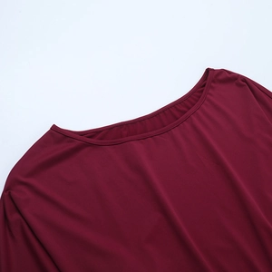 Detailed close-up of wine red lace stitching and neckline texture on a sleek corset top