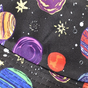 Macro detail of starry space print on black bucket hat with neat stitching texture