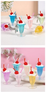 Detail of colorful resin dessert cup keychains with star-shaped metal clips and straws