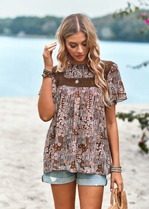 Detail of floral printed top featuring lace patchwork and casual round neckline style