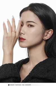 Close-up of a model wearing an elegant gold ring with white agate and matching earrings