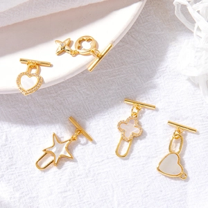 Gold-plated heart, star, and clover OT toggle clasps with white shell and zircon accents