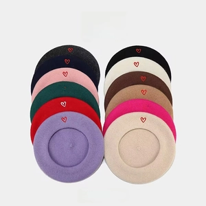 Classic wool beret collection featuring heart embroidery in multiple colors on gray background