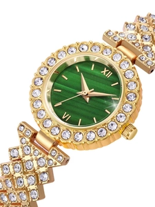 Close-up of gold ladies watch with green sunburst dial and sparkling crystal bezel