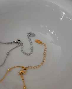 Detail of 18k gold and silver steel snake bone chain with lobster clasp and extender