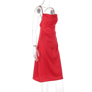 Detail of red satin strap dress showing smooth texture and side tailoring on a mannequin