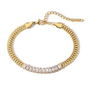 Detailed close-up of gold titanium steel bracelet with rectangular zircon inlay and S.STEEL tag