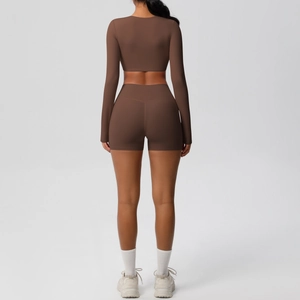 Detail view of coffee-colored brushed yoga set featuring a back-less long sleeve crop top