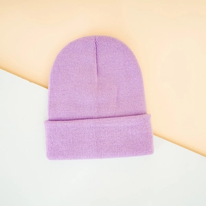 Detailed texture of the purple knitted beanie cuff on a minimalist bicolor background