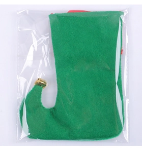 Close-up of green Christmas elf boot stocking with red trim and a golden jingle bell detail