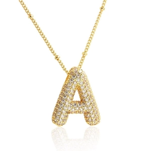 Detail of puffed 18K gold letter A pendant with shimmering pavé zircon micro-setting