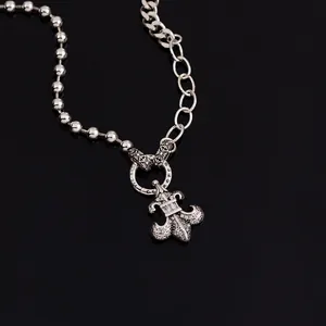 Silver dual-chain hip hop necklace with fleur-de-lis zircon pendant on black reflection