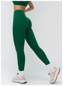 Close-up of high-waisted dark green yoga leggings with premium matte texture and elasticity