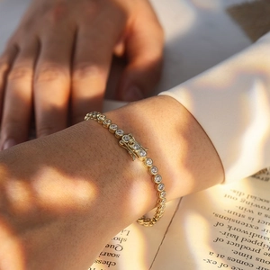 Detailed shot of a gold-plated S925 silver tennis bracelet with round cubic zirconia on a wrist