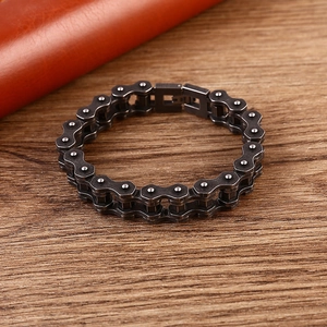 Rugged men's stainless steel bicycle chain bracelet in gunmetal finish on wood
