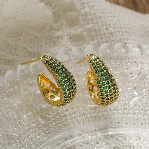 Elegant gold plated C-shaped hoop earrings with green zircon pavé on glass base