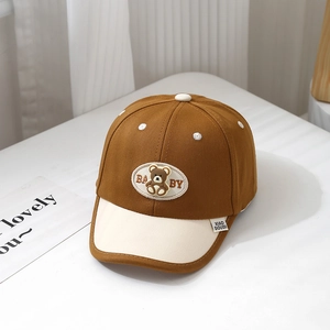 Detailed macro view of cotton baby baseball cap featuring brown and cream color blocking