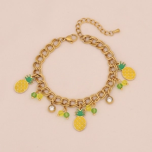 Close-up of gold chain necklace featuring pineapple charms and colorful crystal beads