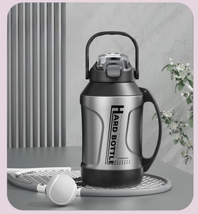Detail of steel sports water bottle with ergonomic handle and secure locking flip lid