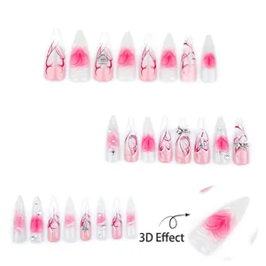 3D press-on nails with pink gradient, silver metal bows, and long stiletto shape