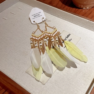 Bohemian teardrop earrings with yellow and white feathers and silver hooks