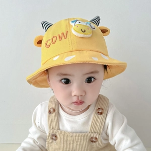 Detail of yellow cotton toddler bucket hat with cute cow ears and 3D doll patch