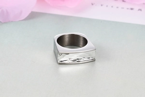 Macro detail of silver rectangular gemstone ring with thick polished metal band