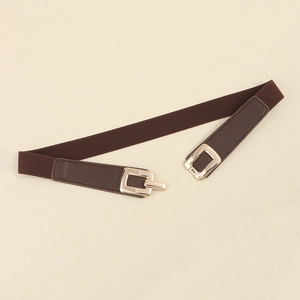 Detail of dark brown elastic belt with litchi grain leather and gold rectangular buckle