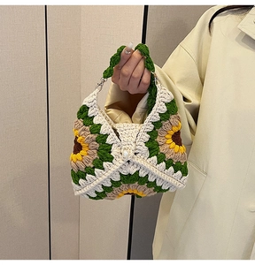 Close-up of handmade sunflower crochet bag with woven texture and pearl button detail