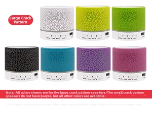 Detailed view of portable crackle-pattern Bluetooth speakers in seven vibrant colors