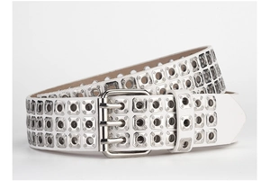 Detail of white PU leather punk belt with three rows of silver metal eyelets and triple pin buckle