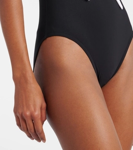 Detail of black V-neck swimsuit featuring high-cut leg design and premium matte texture
