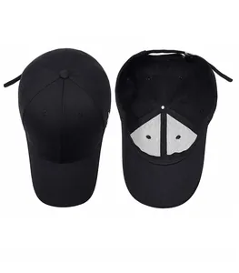 Detail view of the structured crown and internal lining of a black cotton baseball cap