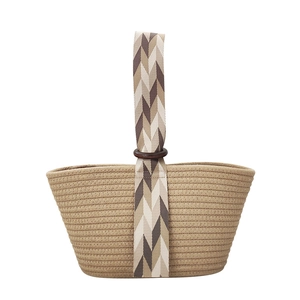 Minimalist woven cotton rope handbag with geometric patterned strap and wooden ring detail