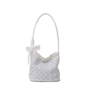 White hobo shoulder bag with black polka dots and a decorative white lace bow