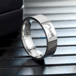 Macro view of polished titanium steel ring with I love you and signature engravings