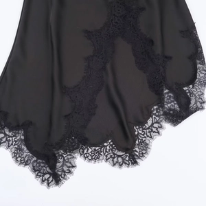 Women's black satin dress with elegant lace trim hem detailing for a sleek fashion look