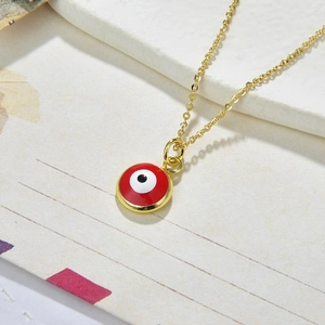 Close-up of golden red Evil Eye pendant necklace with detailed enamel finish on chain