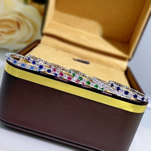 Macro shot of colorful gemstone eternity ring displayed in a jewelry box with roses