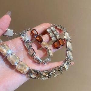 Detail of luxury necklace and bracelet set with square amber and clear gemstones