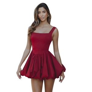 Detail of burgundy sleeveless mini dress featuring a square neck and pleated puffy skirt