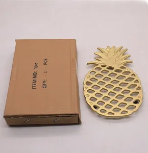 Detail of golden pineapple trivet set with hollow diamond pattern and non-slip feet