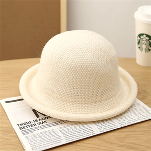 Close-up of off-white knitted bucket hat showing premium wool texture and rolled brim