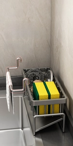 Detail of grey kitchen sink caddy with removable bar for dishcloth and sponge storage