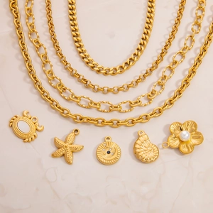 Detailed flat lay of 18K gold plated ocean pendants including crab, starfish and shell