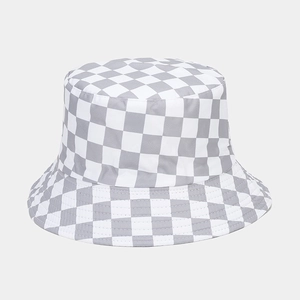 Detailed view of gray and white checkerboard pattern on cotton bucket hat with stitching