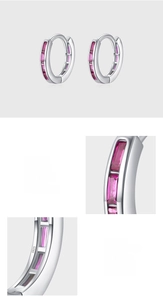 Macro detail of S925 sterling silver hoop earrings with pink rectangular zircon bezel setting